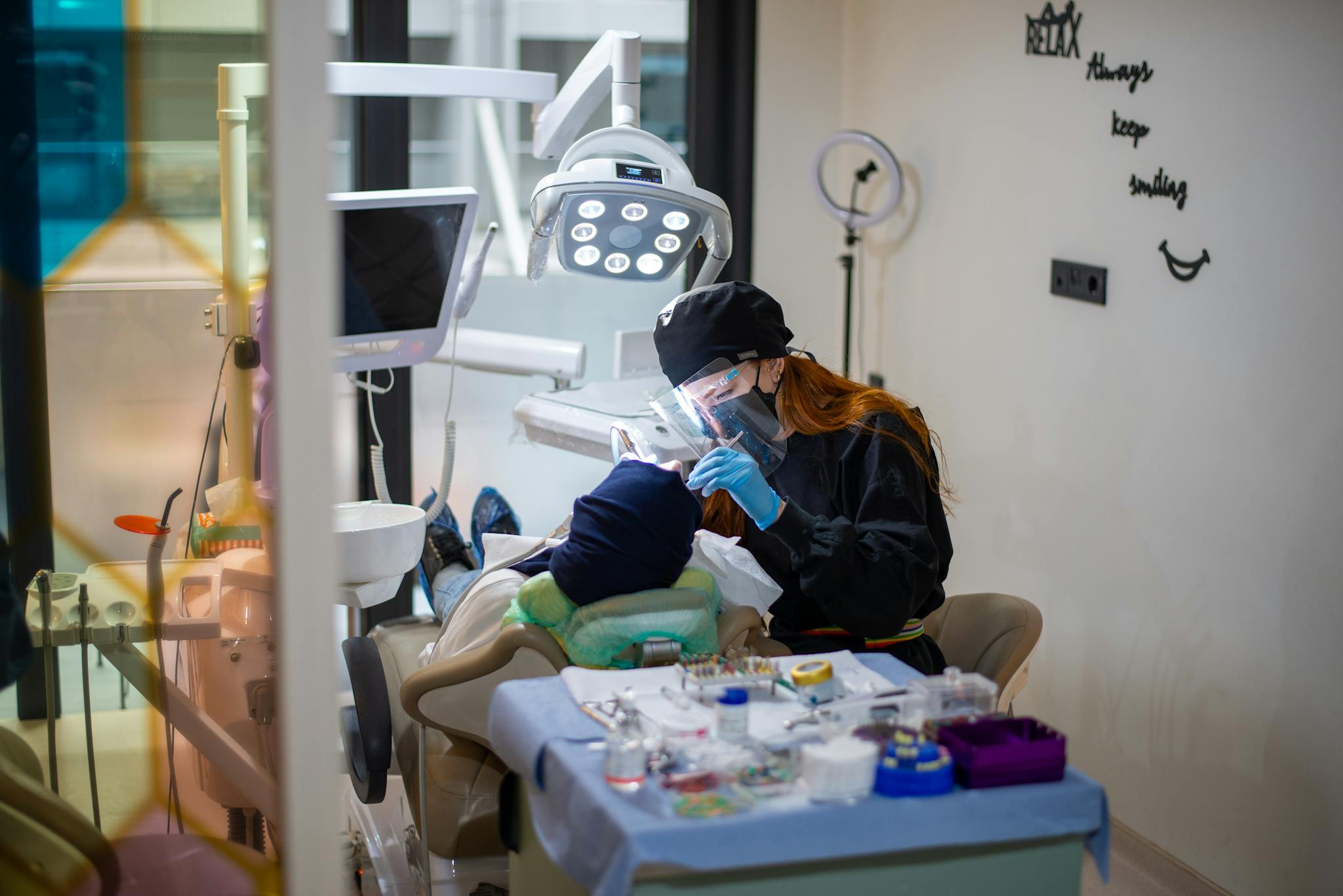 Dentist performing a dental checkup with advanced equipment in a contemporary clinic.