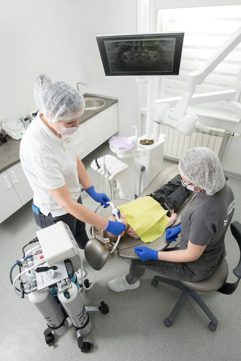 Overhead view of a dental procedure with a dentist and patient, showcasing modern dental equipment and care.
